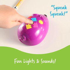 Interactive STEM toy, Learning Resources Code & Go Robot Mouse, held by person with light bulb.
