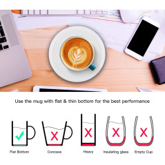 A white mug filled with latte art sits on a sleek white heating coaster, with steam rising from the cup.